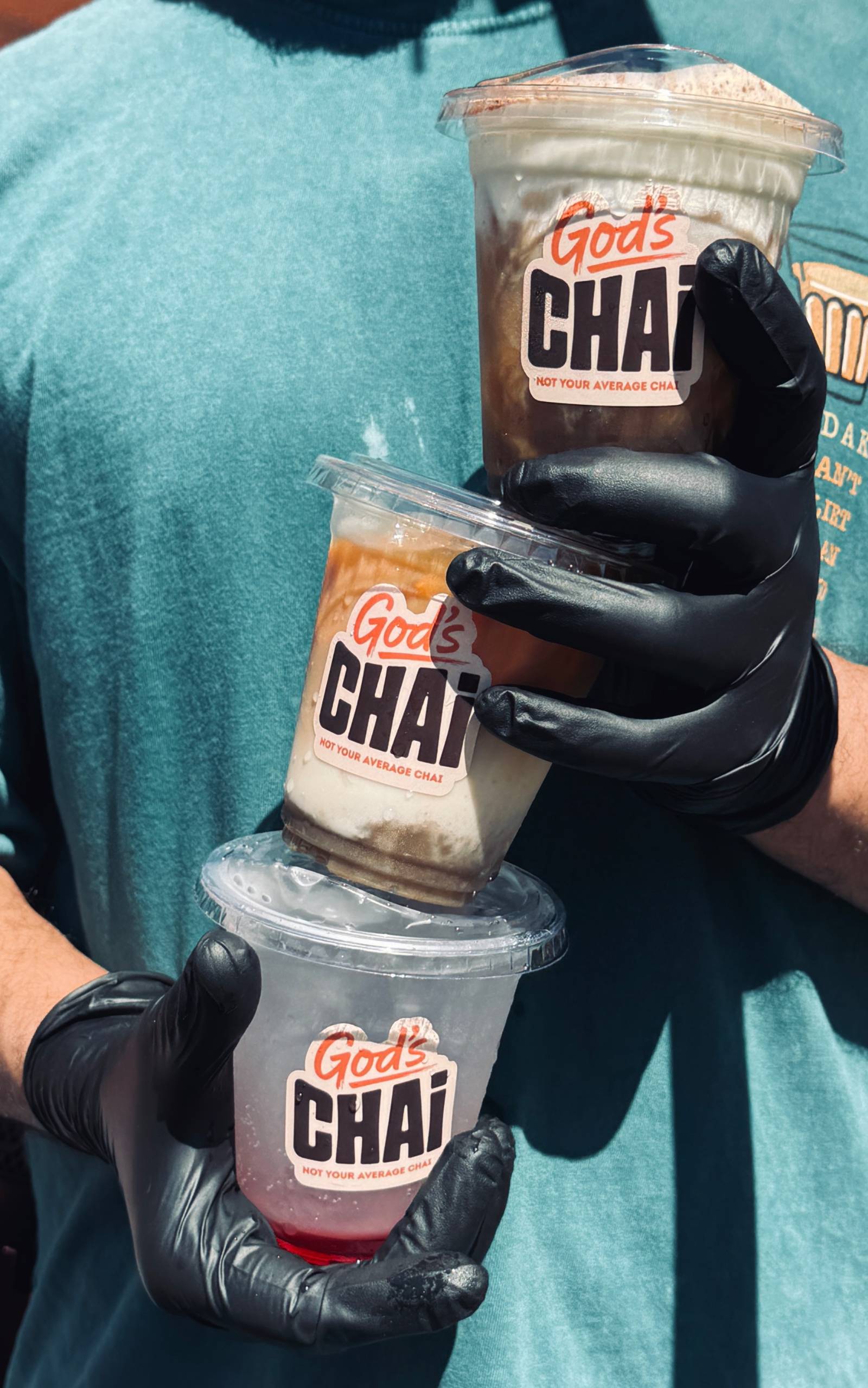 Three God's Chai cups held stacked at the cart in Saskatoon